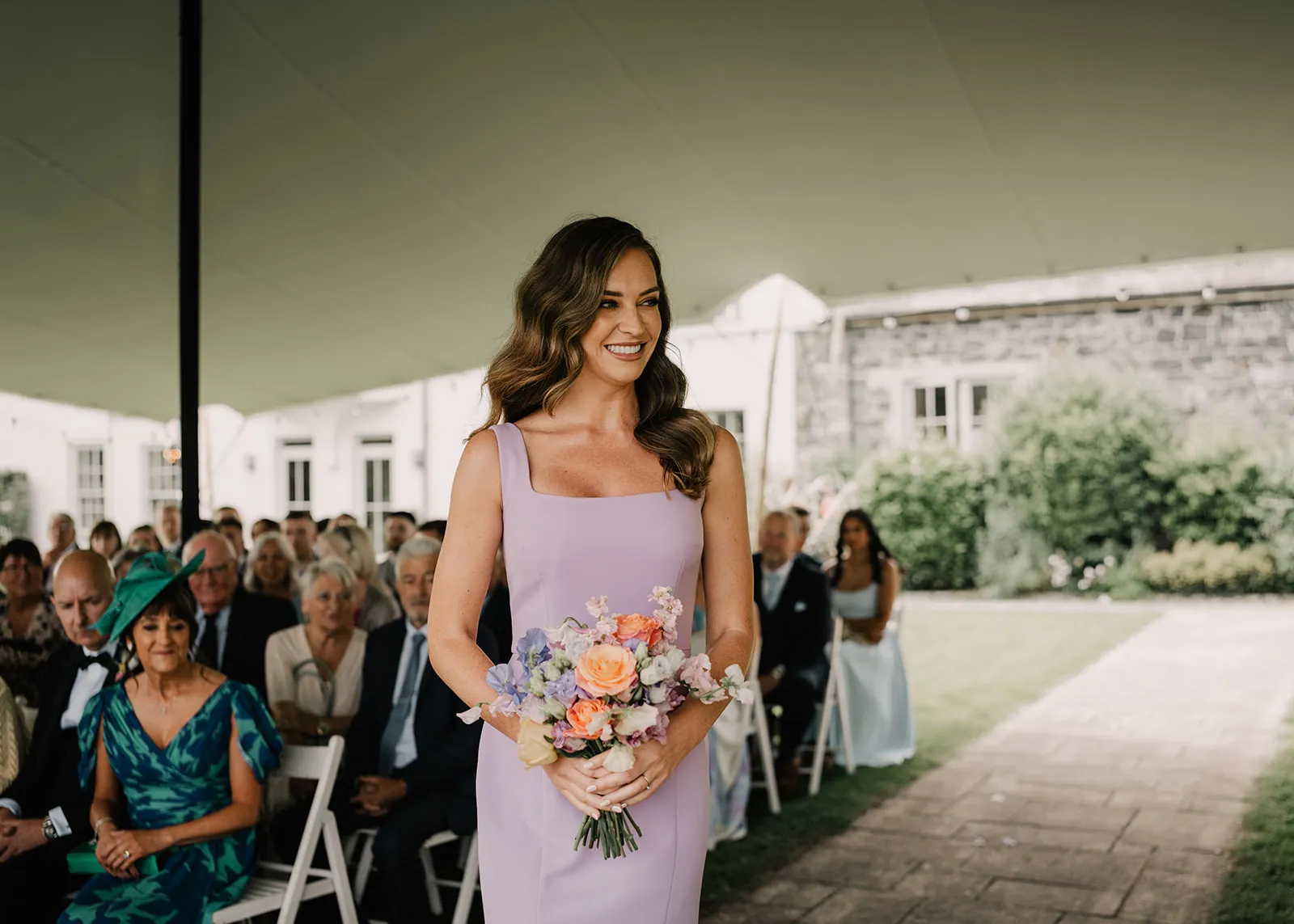 photos of a bridesmaid in a ceremony on the gardens in front of the Georgian house